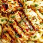 A plate of Power-Packed Grilled Chicken Alfredo featuring tender grilled chicken slices over creamy Alfredo pasta, garnished with fresh herbs.