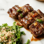 A vibrant plate of pepper steak showcasing tender beef slices coated in a glossy, savory sauce with sliced bell peppers and onions, garnished with fresh herbs, on a rustic wooden table with colorful vegetables and a side of rice.